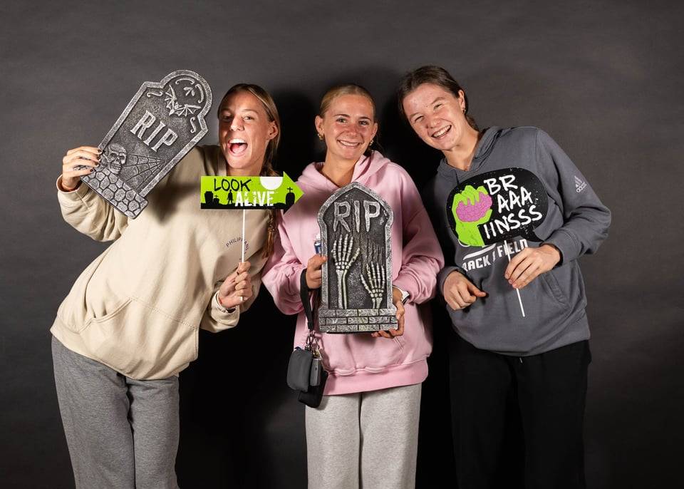 Students with tombstone props at a photobooth